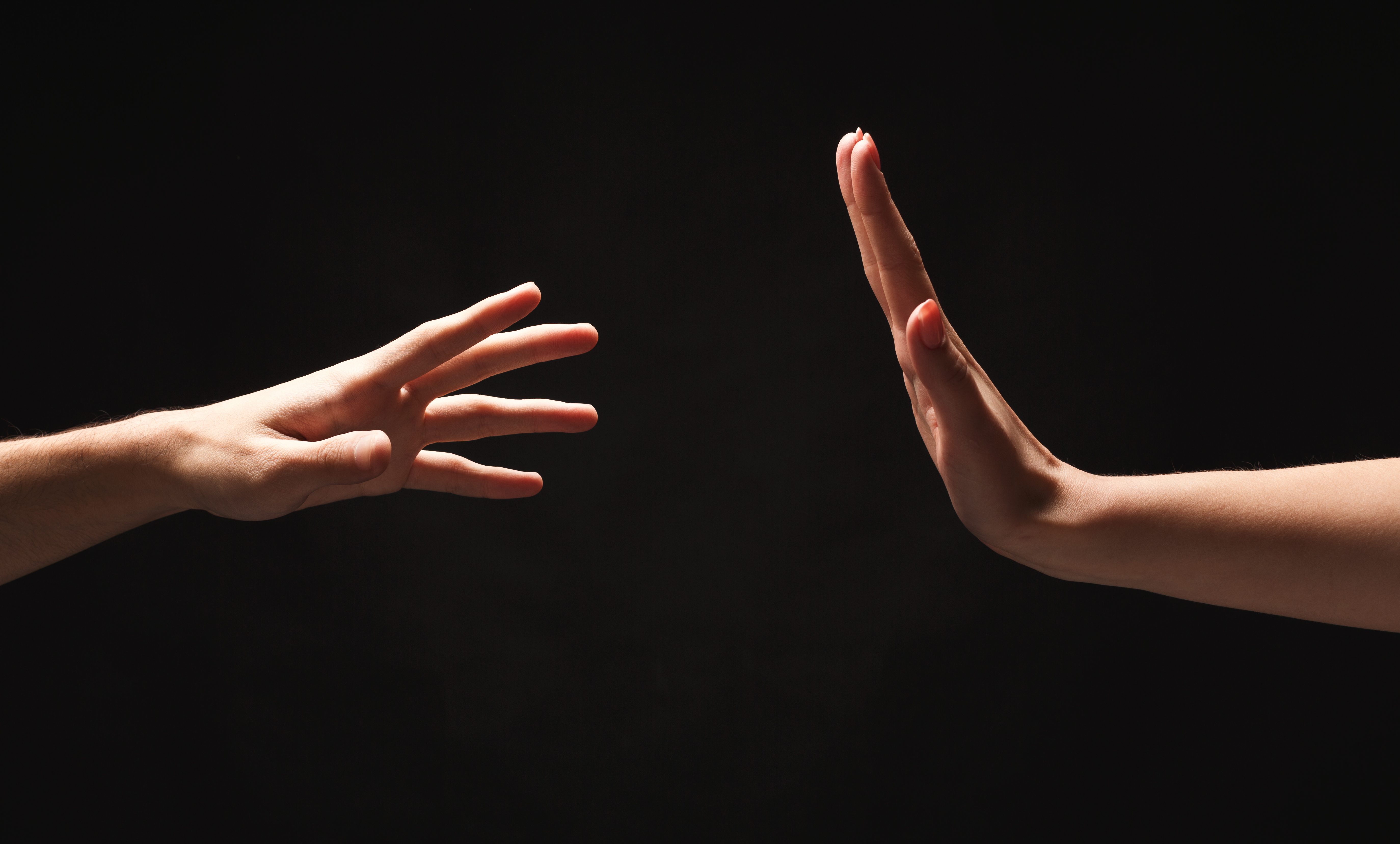 Male and female hands on black isolated studio background
